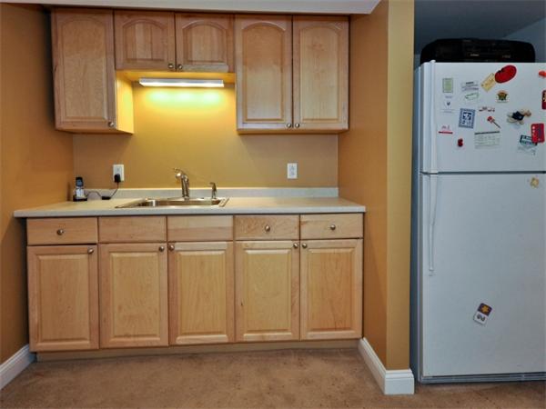19 Colonial Road Needham, MA 02492 - Photo 23 of 30 a kitchen with white cabinets and sink