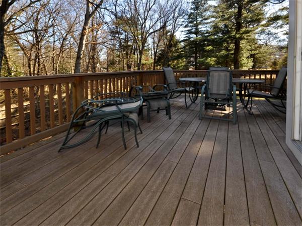 19 Colonial Road Needham, MA 02492 - Photo 4 of 30 a view of a roof deck with table and chairs wooden floor and fence