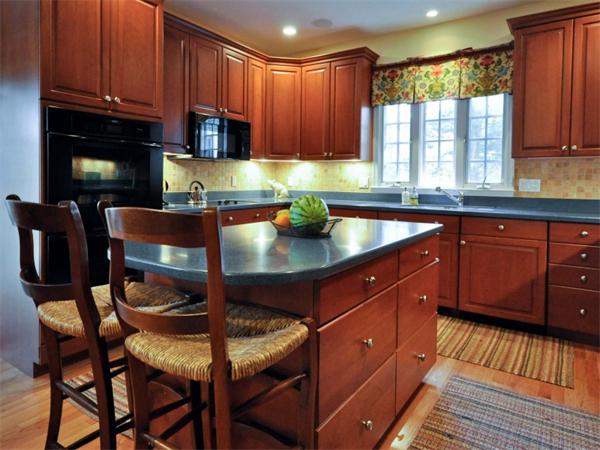 19 Colonial Road Needham, MA 02492 - Photo 5 of 30 a kitchen with granite countertop a dining table chairs cabinets a sink and a window