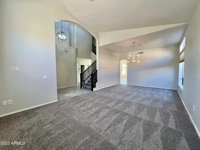 a kitchen with stainless steel appliances kitchen island granite countertop a sink and stove top oven with wooden floor