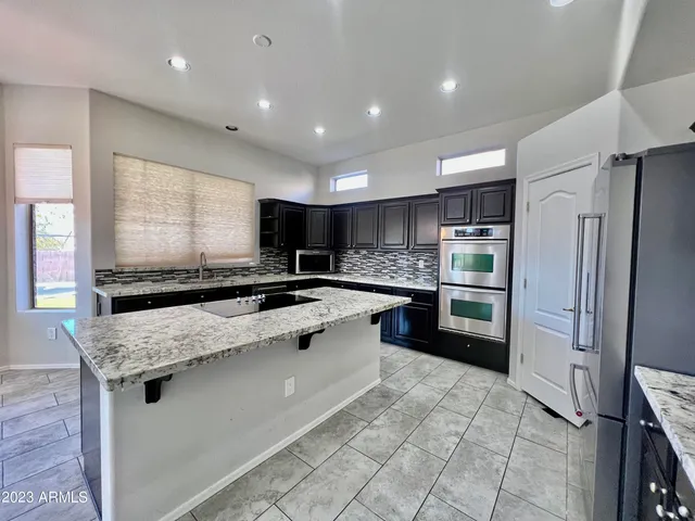 a bathroom with a double vanity sink toilet and mirror