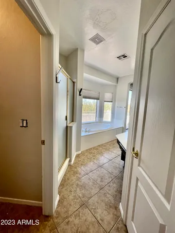 a view of a livingroom with a ceiling fan and window