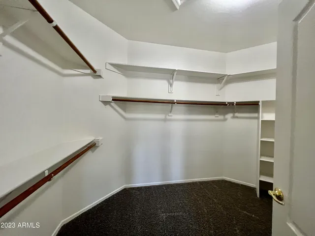 an empty room with windows and fireplace