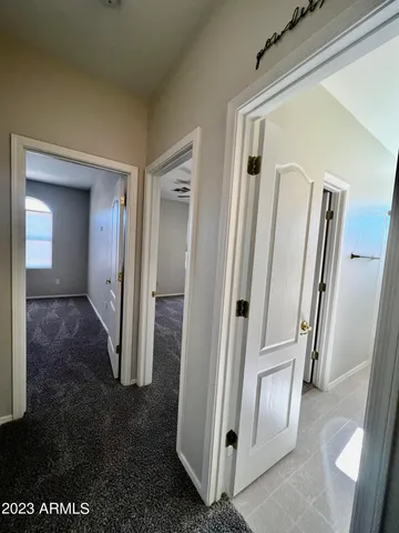 a view of a patio with a table and chairs under an umbrella