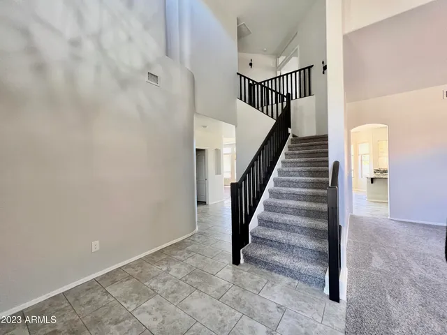 a large kitchen with stainless steel appliances a large counter top a stove and a sink