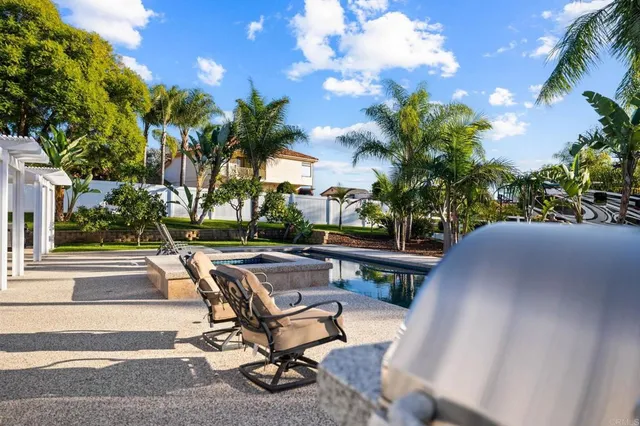 a view of a patio with swimming pool table and chairs