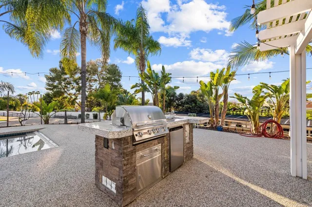 a view of a chairs and table in the back yard of the house