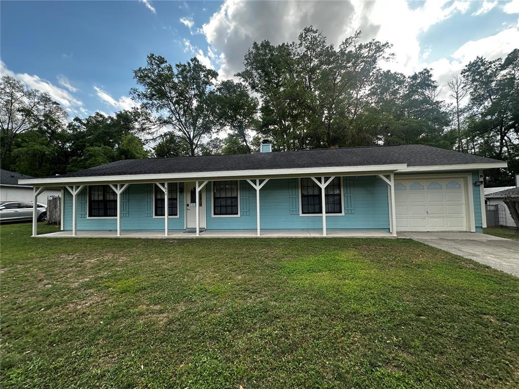 44 Teak Road Ocala, FL 34472 - Photo 1 of 12 a front view of a house with a yard