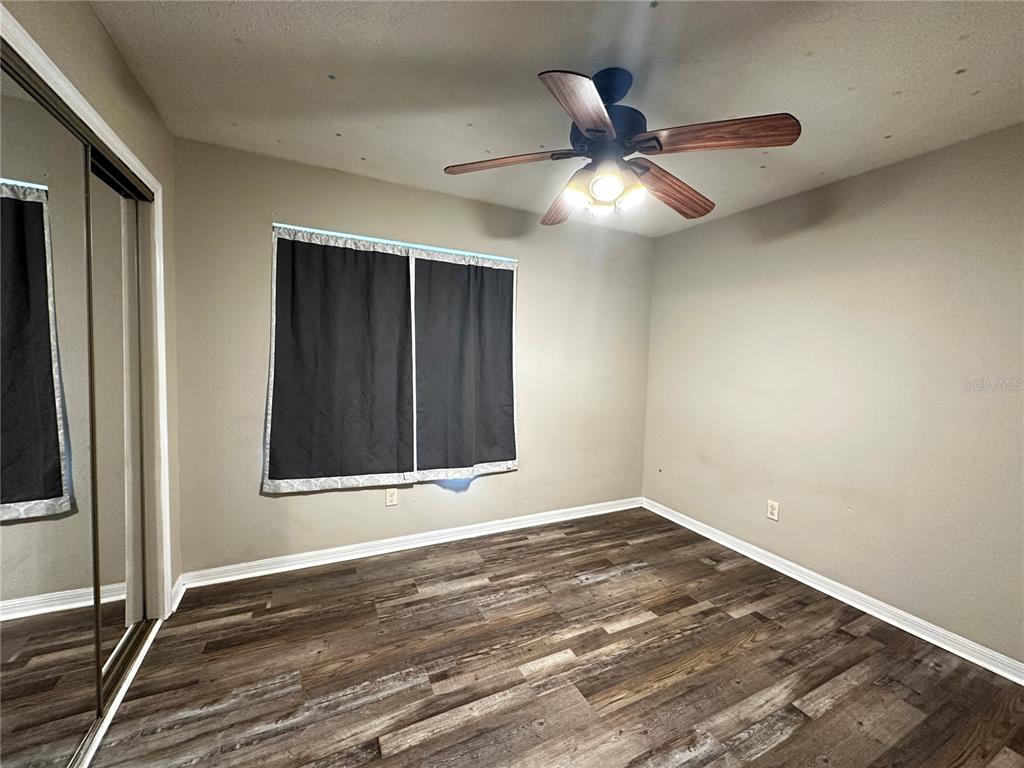 44 Teak Road Ocala, FL 34472 - Photo 5 of 12 a view of an empty room with wooden floor and a window
