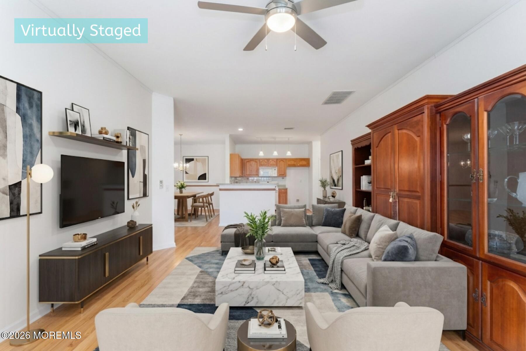 22 Foxwood Road Lakewood, NJ 08701 - Photo 12 of 35 a living room with furniture a flat screen tv and kitchen view