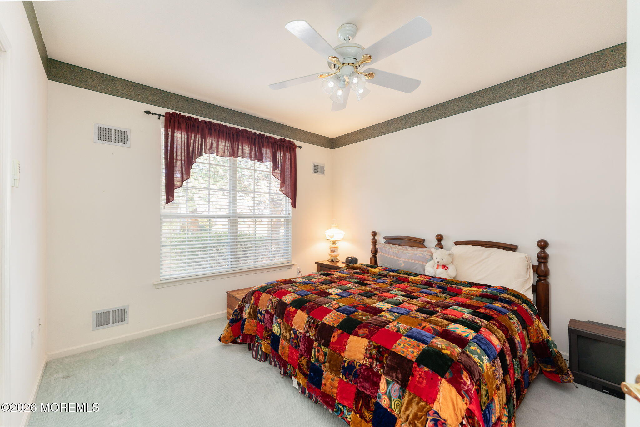 22 Foxwood Road Lakewood, NJ 08701 - Photo 22 of 35 a bedroom with a large bed and a chandelier
