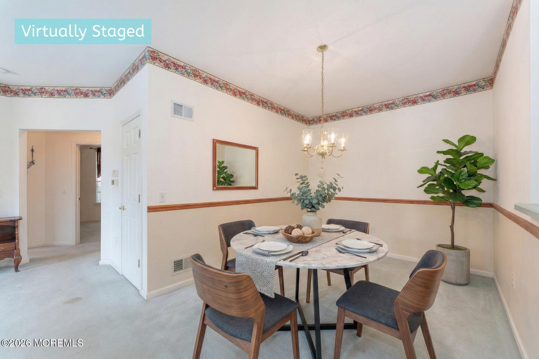 22 Foxwood Road Lakewood, NJ 08701 - Photo 10 of 35 a dining room with furniture potted plants and a chandelier