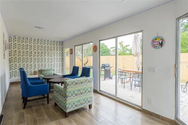 a living room with furniture and a floor to ceiling window