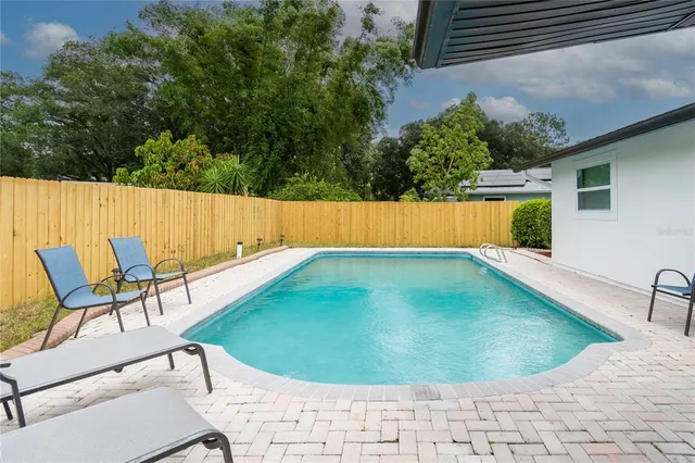 a view of a swimming pool with a lounge chair