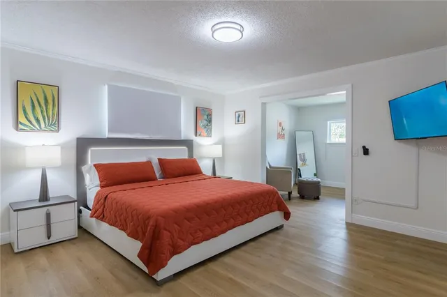 a bedroom with a bed and a night stand