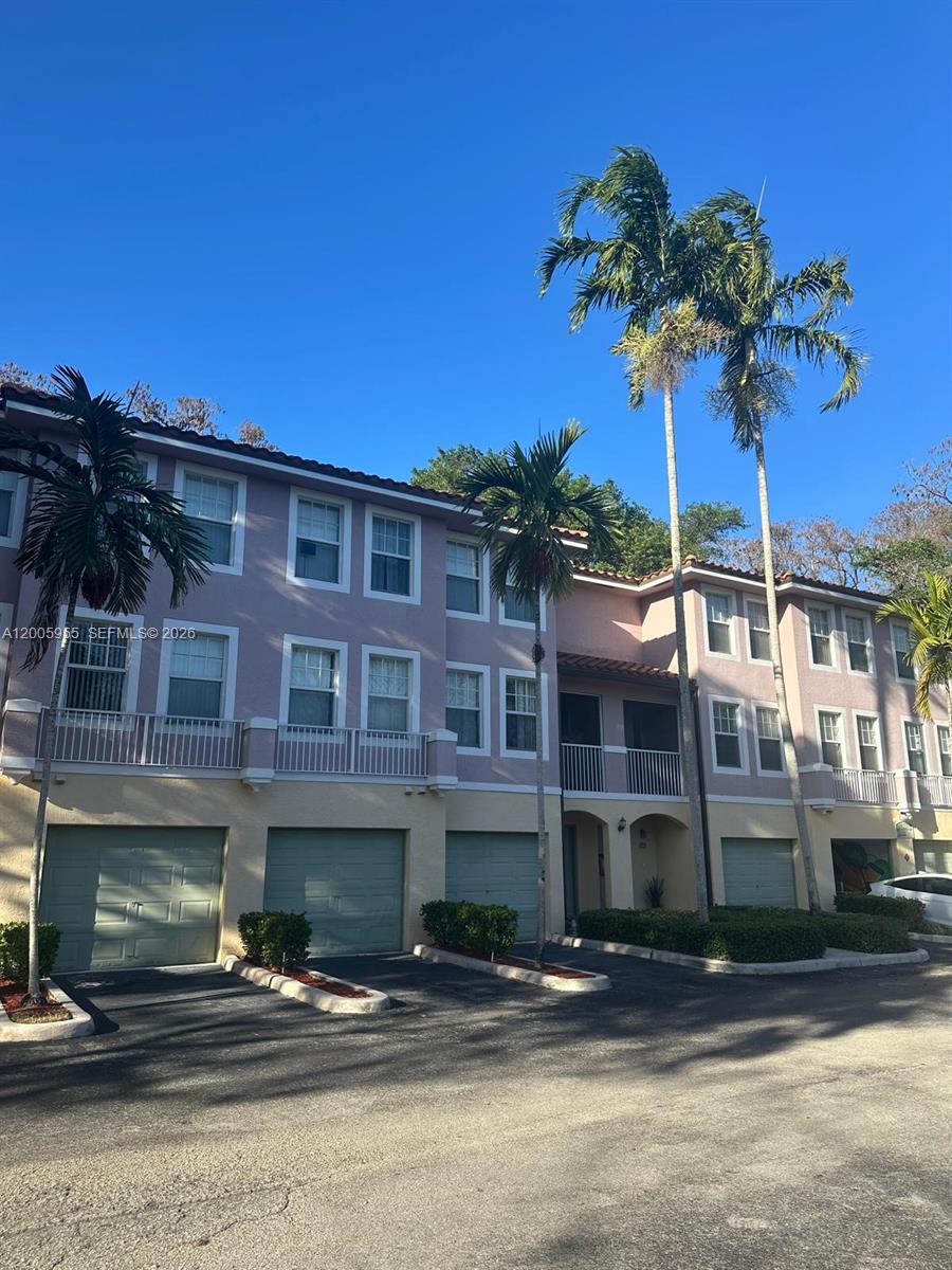 6920 West Sample Road, Unit 6920 Pompano Beach, FL 33063 - Photo 3 of 30 a front view of a building with entryway