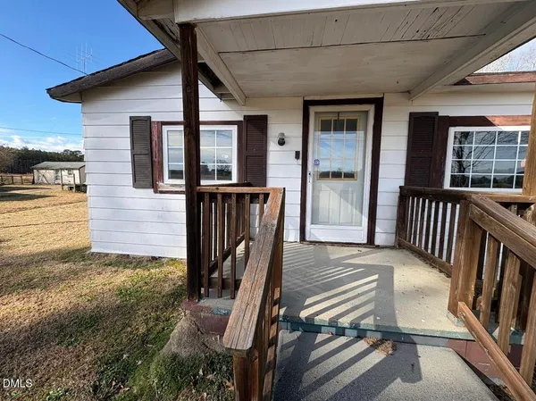 a view of balcony with wooden floor and fence