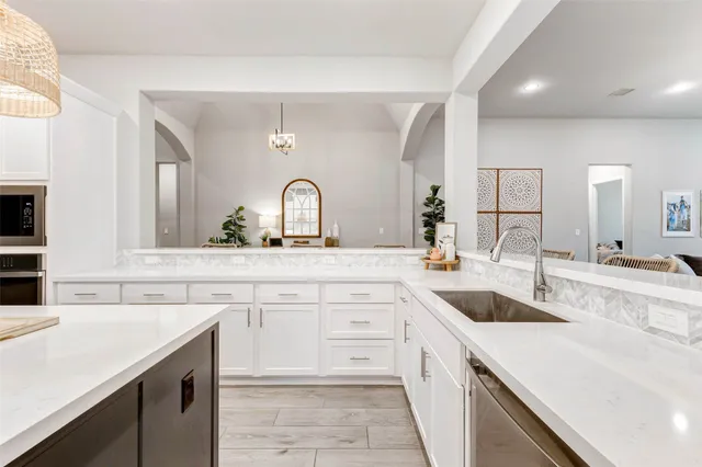 a kitchen with granite countertop a sink and cabinets