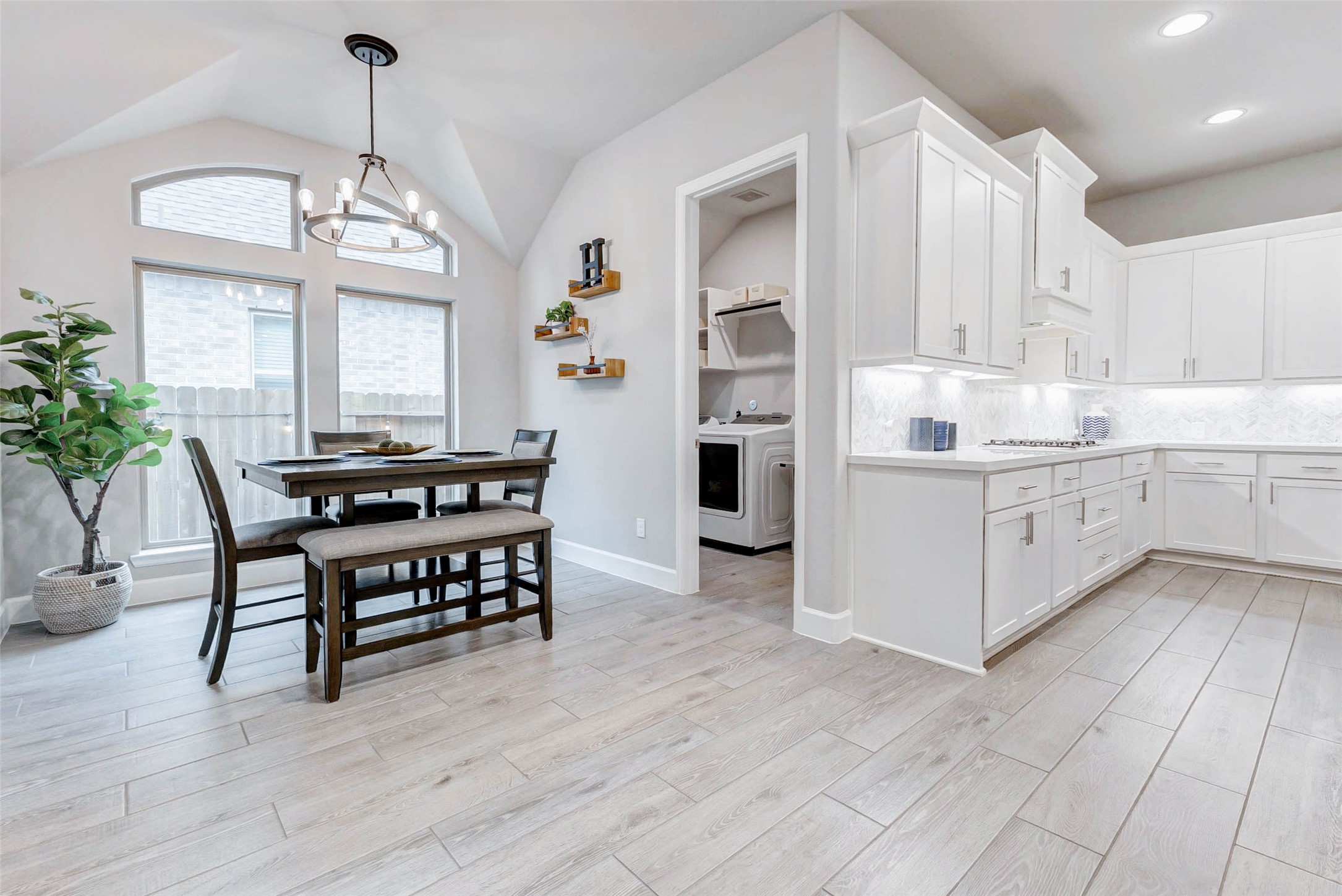 4714 Southpoint Way Fulshear, TX 77441 - Photo 12 of 45 a open kitchen with stainless steel appliances granite countertop a stove refrigerator and a dining table with wooden floor