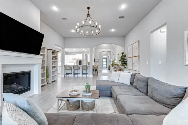 a living room with furniture a table and a large window