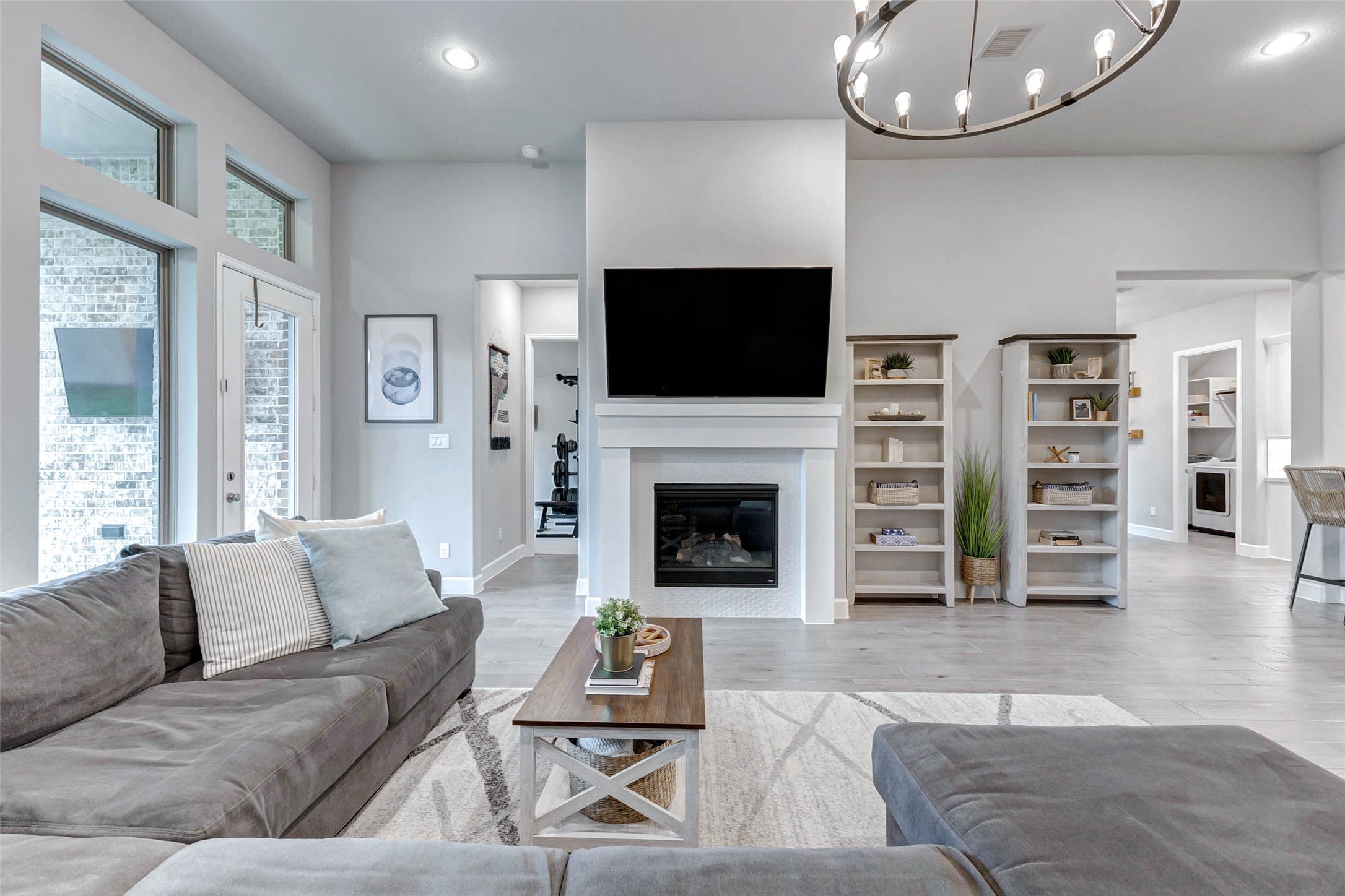 4714 Southpoint Way Fulshear, TX 77441 - Photo 15 of 45 a living room with furniture a flat screen tv and a fireplace