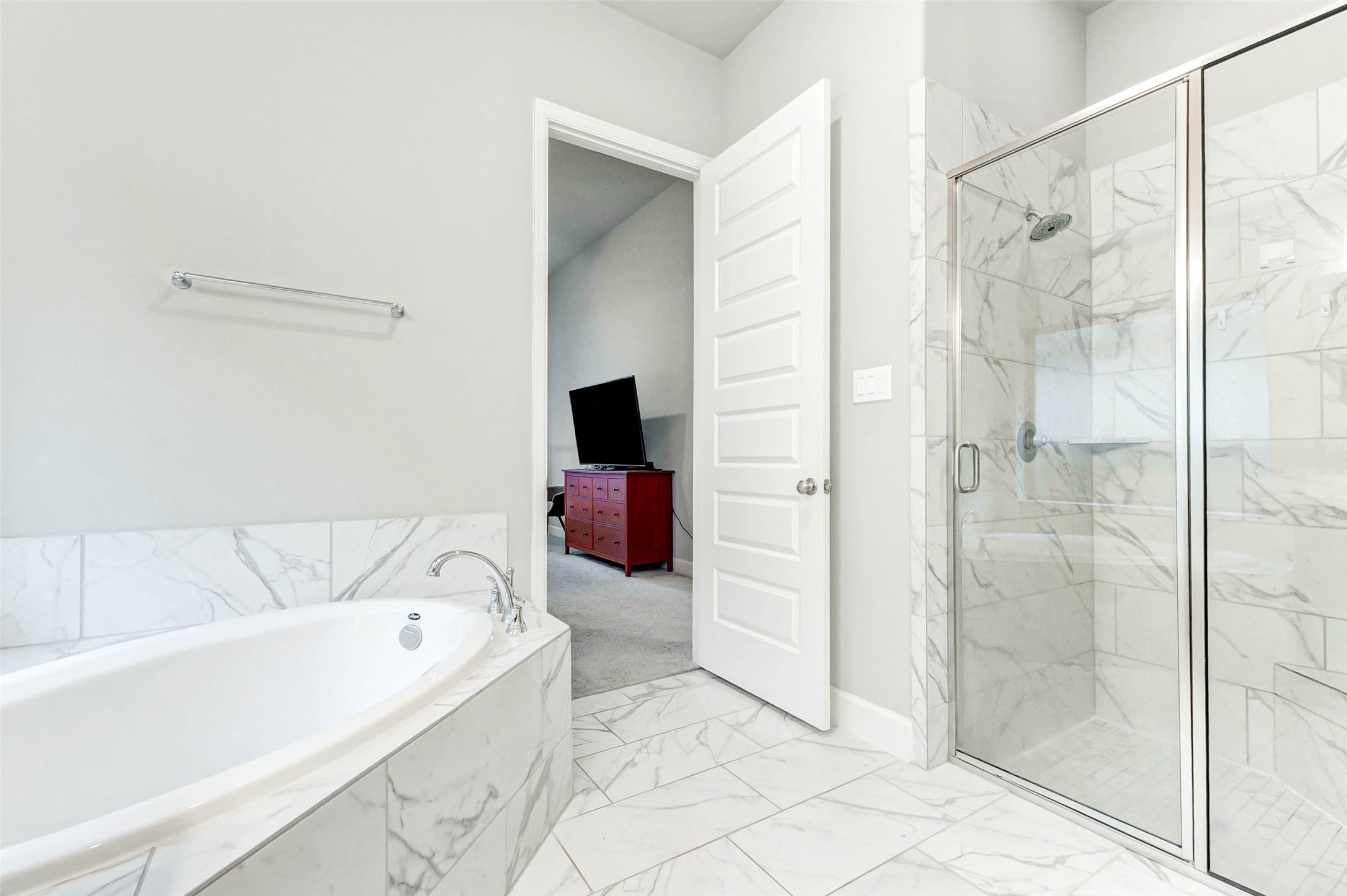 4714 Southpoint Way Fulshear, TX 77441 - Photo 19 of 45 a bathroom with a bathtub and a shower