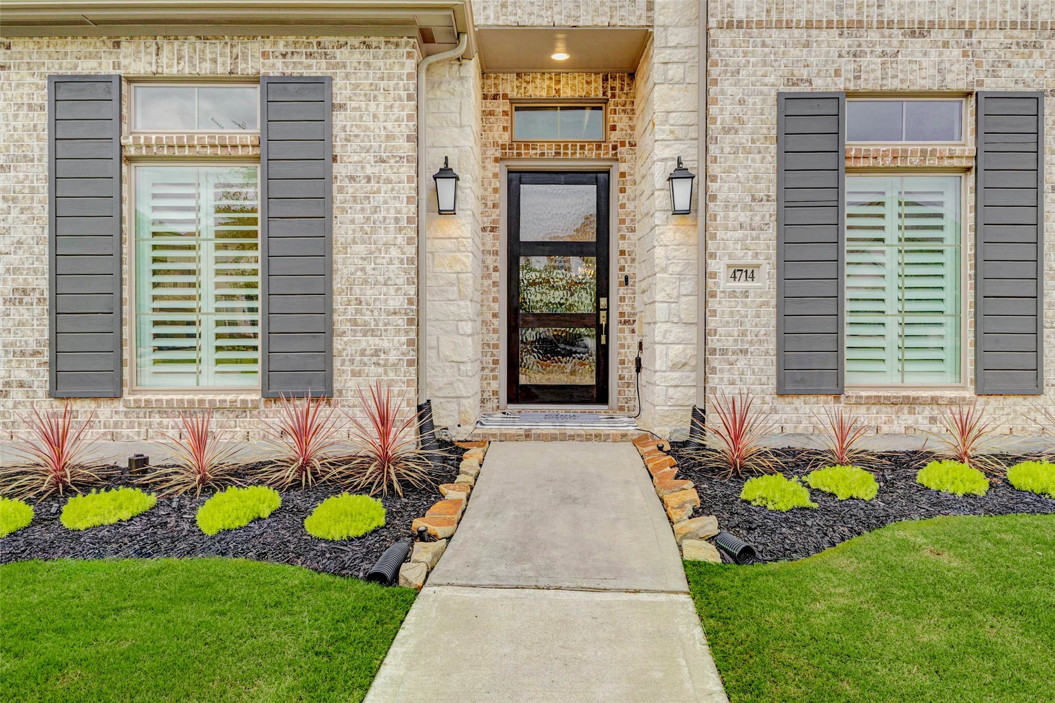 4714 Southpoint Way Fulshear, TX 77441 - Photo 2 of 45 a front view of a house with a garden and chairs