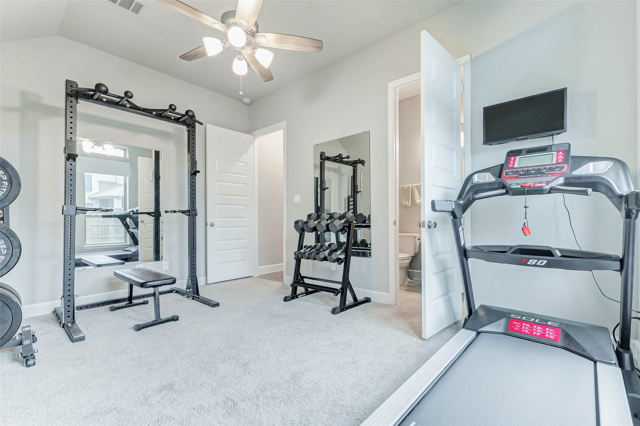 4714 Southpoint Way Fulshear, TX 77441 - Photo 24 of 45 a view of a room with gym equipment