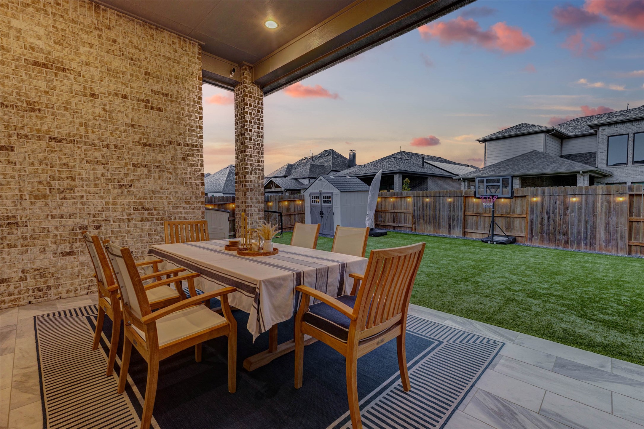 4714 Southpoint Way Fulshear, TX 77441 - Photo 27 of 45 a view of a patio with table and chairs with wooden floor and fence