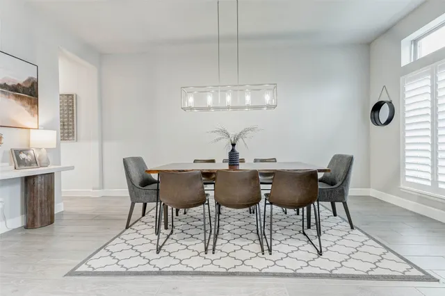 a view of a dining room with furniture and window