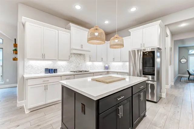 a kitchen with a sink a stove a refrigerator and cabinets