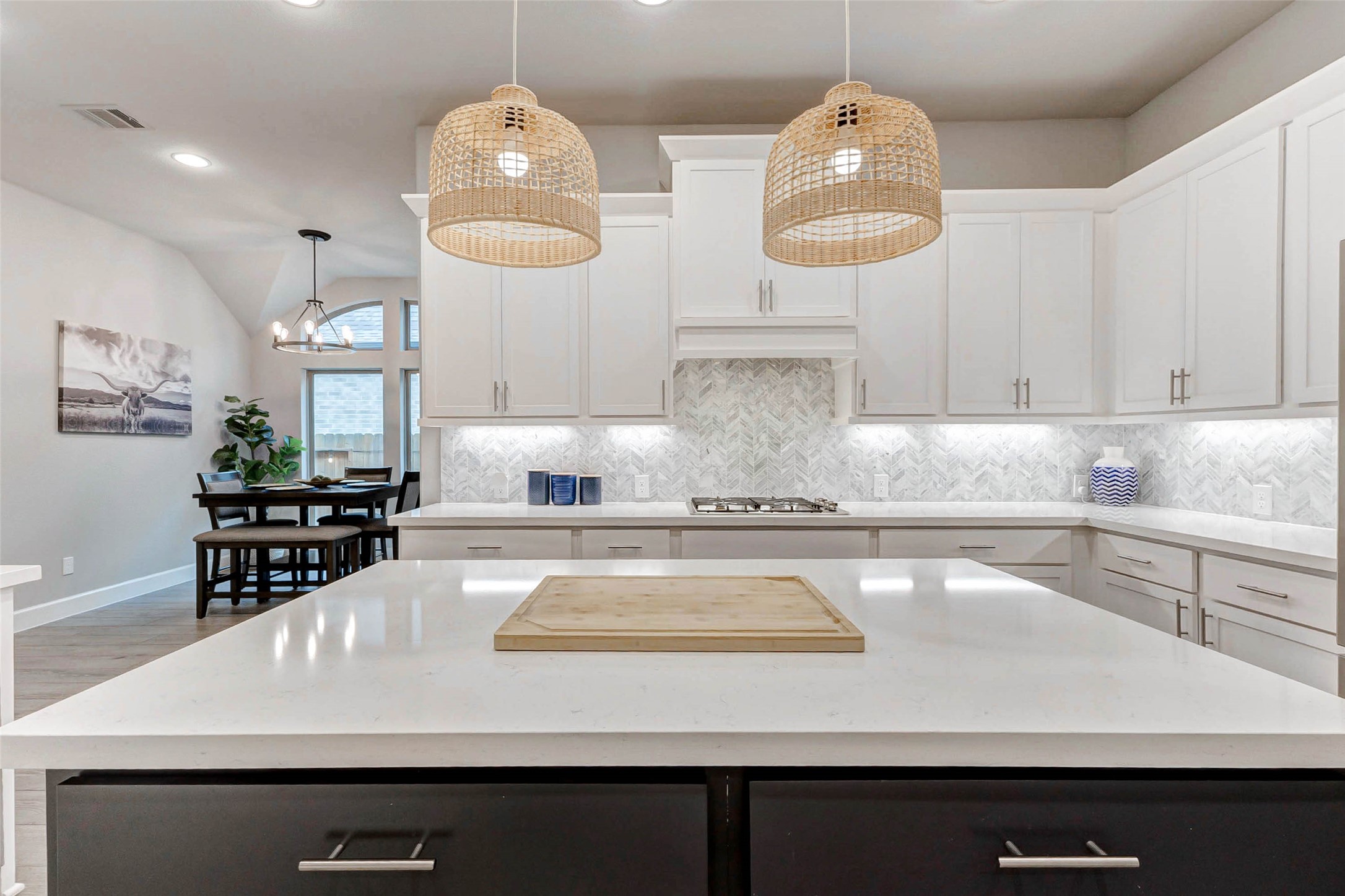 4714 Southpoint Way Fulshear, TX 77441 - Photo 10 of 45 a kitchen with stainless steel appliances granite countertop a sink dishwasher and white cabinets with wooden floor