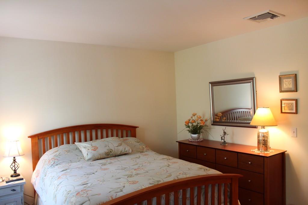 27 A John Dyer Road Little Compton, RI 02837 - Photo 20 of 29 a bedroom with a bed and dresser