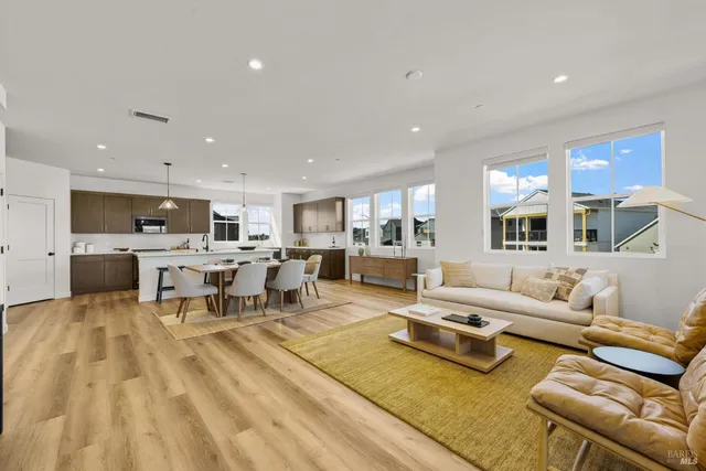 a living room with furniture and kitchen view