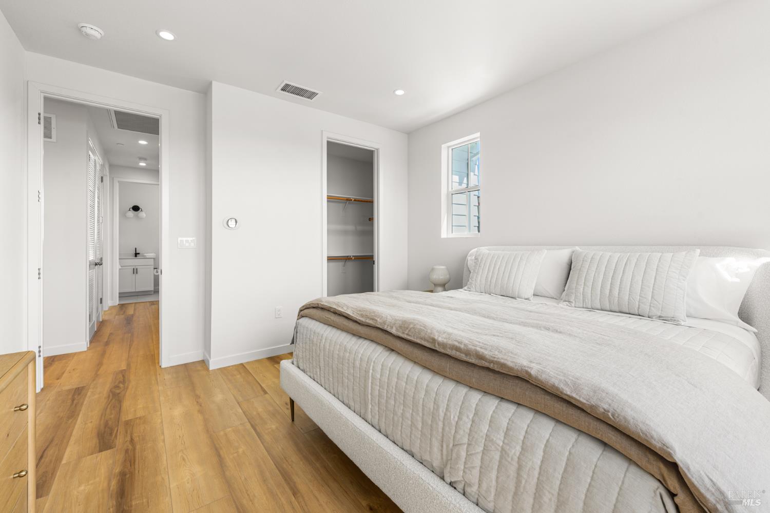 1464 Waterside Lane Rohnert Park, CA 94928 - Photo 13 of 24 a spacious bedroom with a bed and a wooden floor