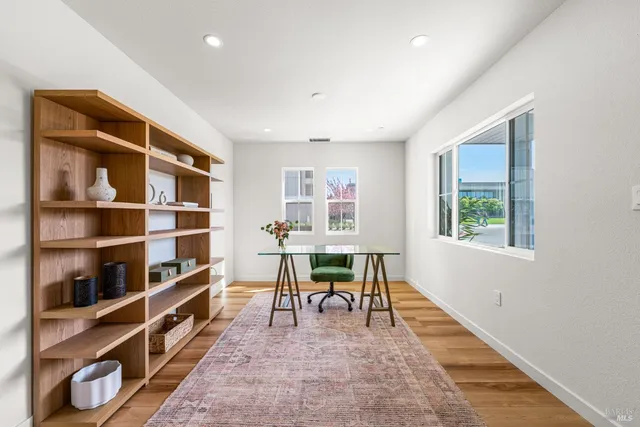 a living room with furniture a rug and a window