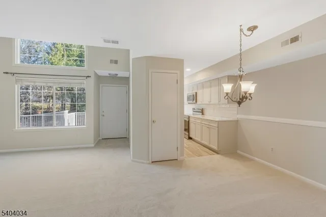 a view of a kitchen with refrigerator and windows