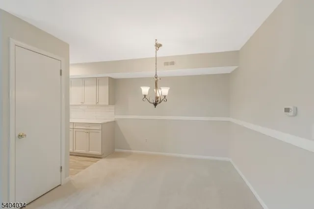 a view of a room with cabinet and chandelier