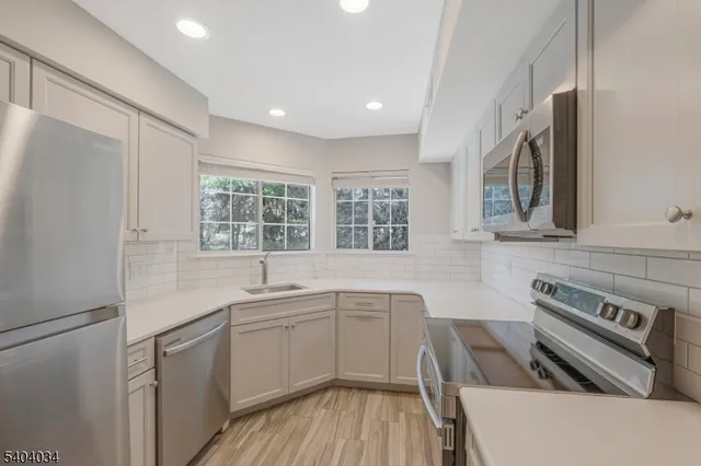a kitchen with a sink stove and microwave