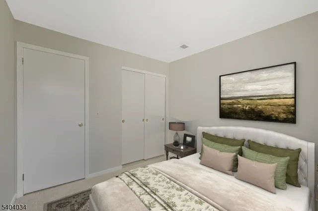 a bedroom with a bed and couch