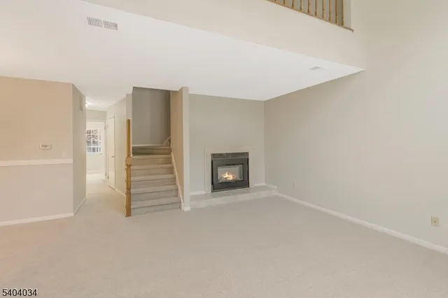 a view of an empty room with a fireplace