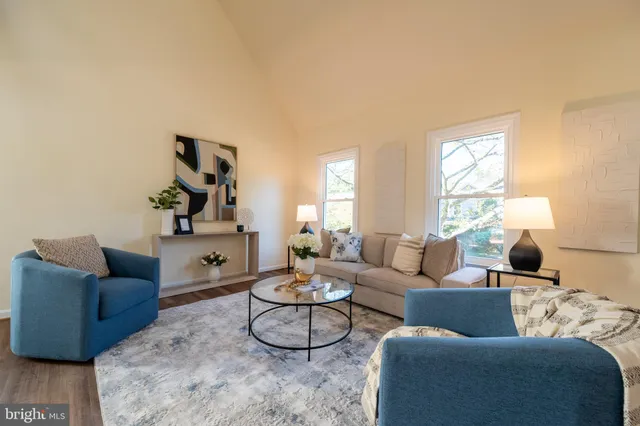 a living room with furniture and a dining table