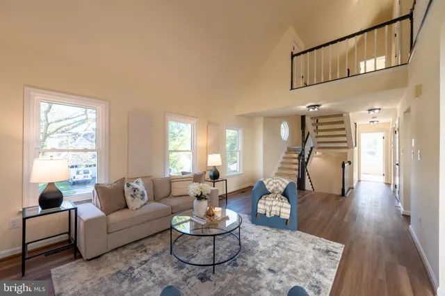 a dining room with furniture and wooden floor