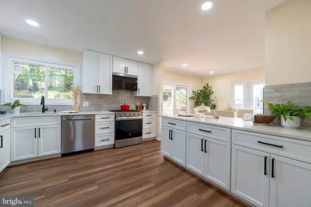 a bathroom with a double vanity sink toilet mirror and shower
