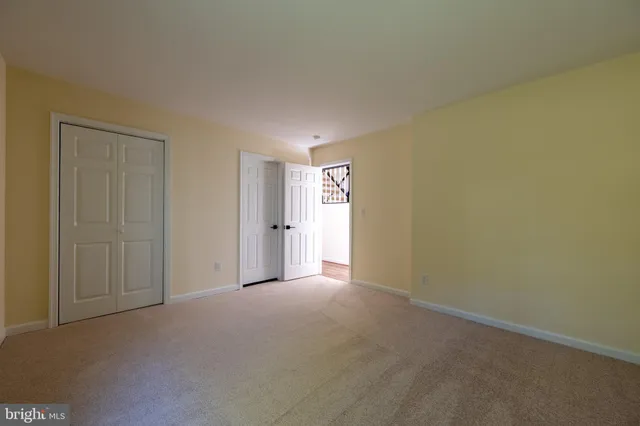 a spacious bedroom with a bed and a chandelier