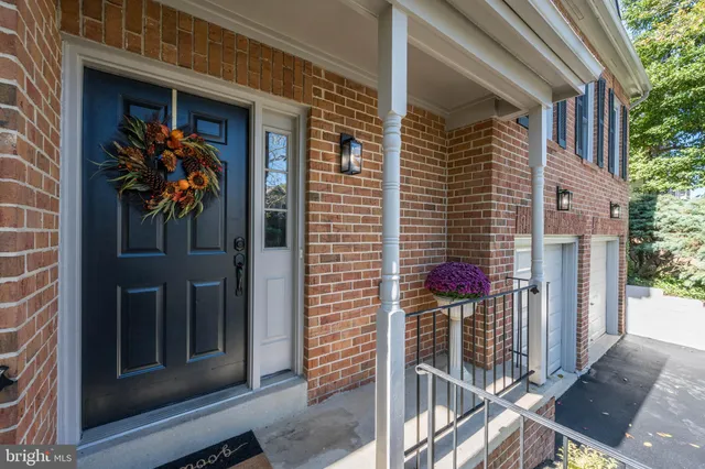 a view of a house with a tree front of the house