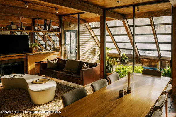 a living room with furniture and a floor to ceiling window