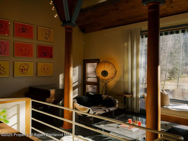 a living room with furniture and a floor to ceiling window