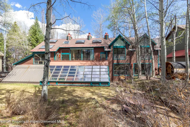 a backyard of a house with barbeque oven