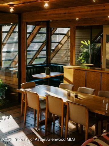 a view of a dining room with furniture and window